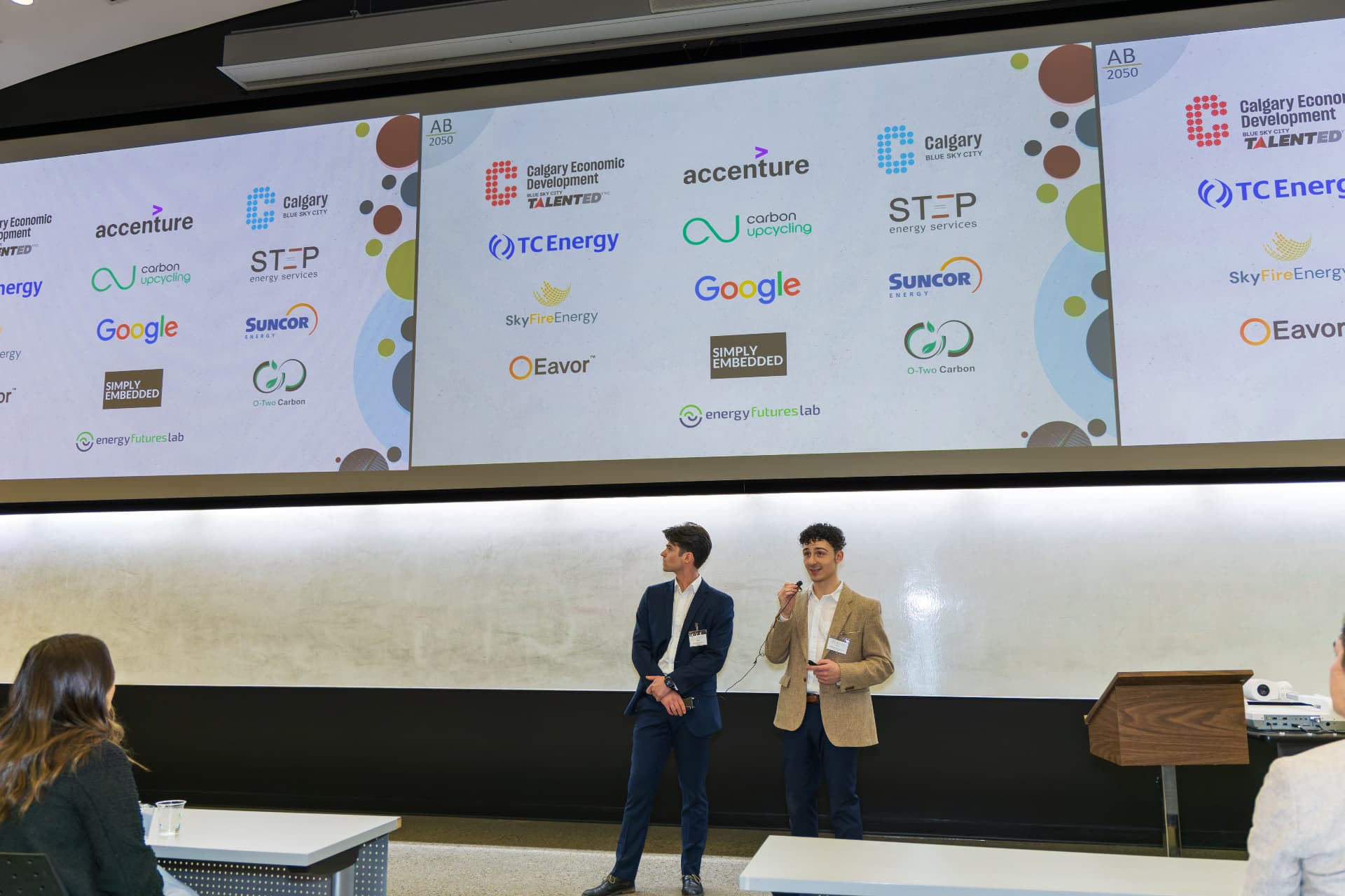 Cameron and Will presenting on stage at the University of Calgary